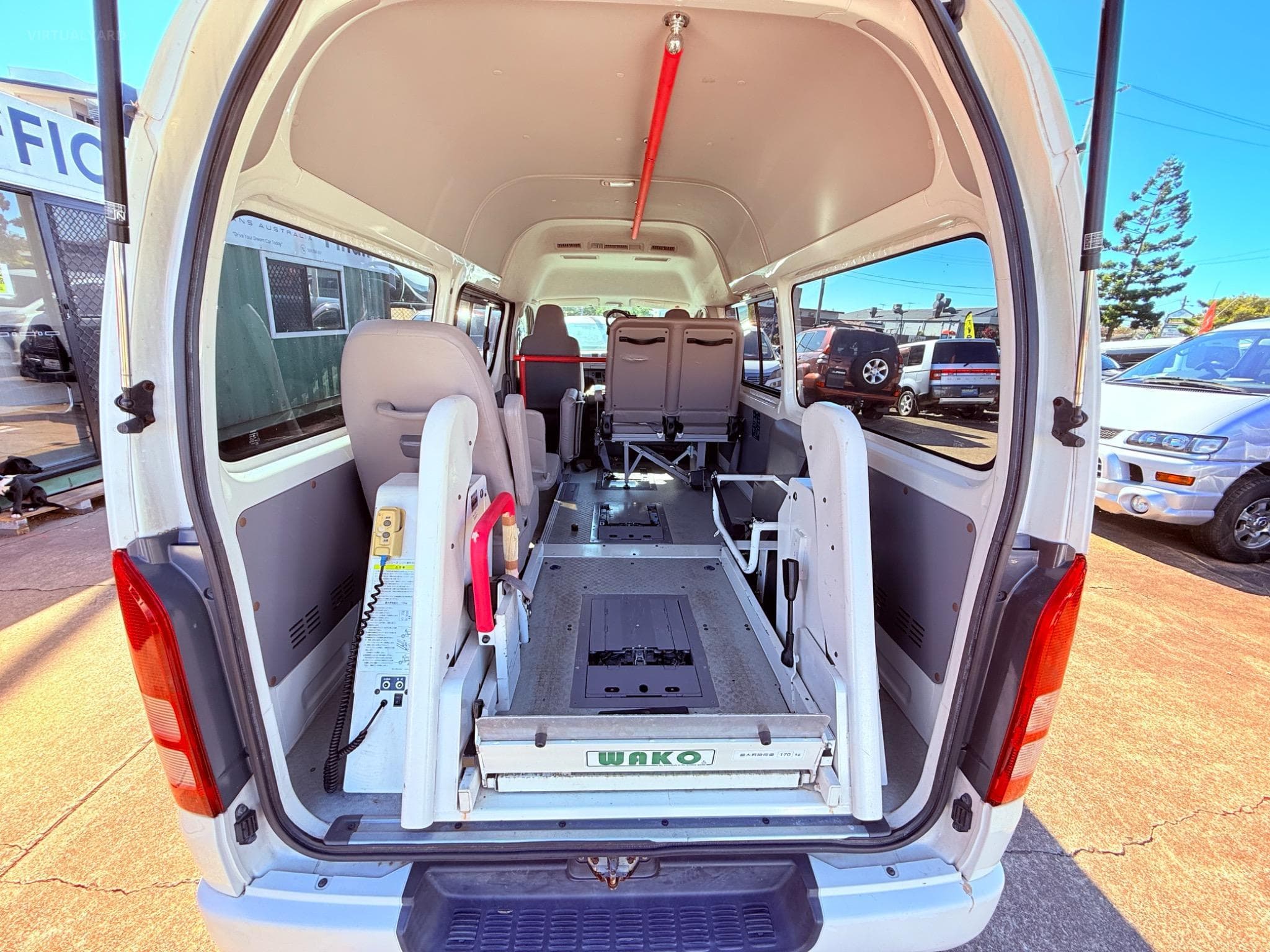 Wheelchair-accessible maxi cab interior with ramp and restraints